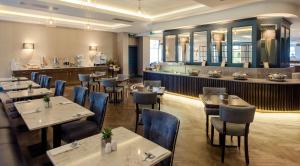 um restaurante com mesas e cadeiras e um bar em Waterford Viking Hotel em Waterford
