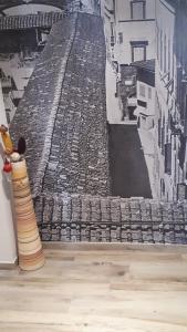 a picture of an image of an ancient city on a wall at La Firenze Sogna in Florence