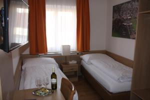 A bed or beds in a room at Weinhotel Rieder