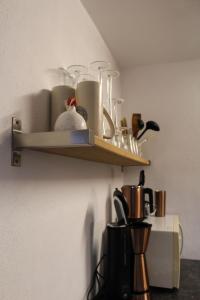 a shelf on a wall with some items on it at Ferienwohnung Teufelsmauer "Waldhaus" in Blankenburg