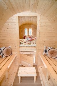 a wooden cabin with two beds in a room at Feriepark Langeland Emmerbølle (Feriepark Langeland) in Emmerbølle