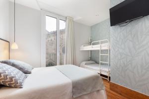 
a bedroom with a bed and a window at Hostal Fernando in Barcelona
