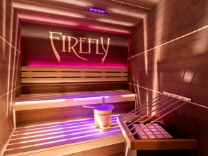 a dimly lit room with a neon sign hanging from the ceiling at Firefly Luxury Suites in Zermatt
