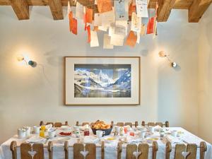 a dining room with a table with food on it at Firefly Luxury Suites in Zermatt