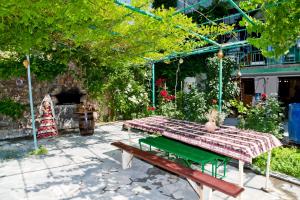 a picnic table in a garden with a bench at Ashtarak Garden GuestHouse in Ashtarak
