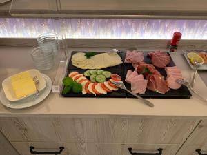 a tray of sushi and meats on a table at Gasthof Scharfe Kurve in Lützow