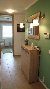 a bathroom with a counter with a mirror and a phone at Ferienwohnungen Göhren in Göhren +92 photos
