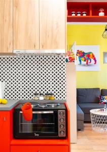 a kitchen with a red oven in a room at Deco city center apartment in Heraklio