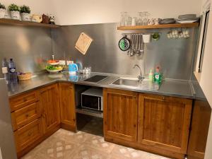 a kitchen with a sink and a counter top at Rose Building Apartment in Cospicua