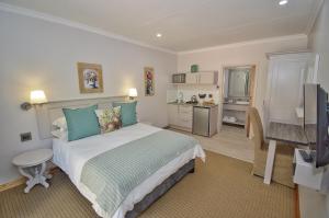 a bedroom with a large bed and a bathroom at Clarens Retreat in Clarens