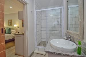 a bathroom with a sink and a shower at Clarens Retreat in Clarens +43 photos