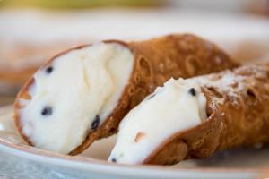 two pieces of bread with cream cheese on a plate at Hotel Biancolilla in San Vito lo Capo