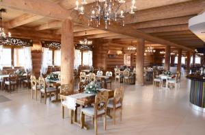 a dining room with tables and chairs in a building at Hotel Świętokrzyski Dwór in Nowa Słupia