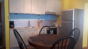 a kitchen with a table and chairs and a refrigerator at BH Rialto in Sveti Stefan