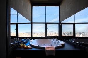 a bathroom with a large tub and a large window at Cityloft 161 in Istanbul