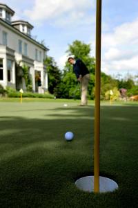 a man is playing golf on a putting green at Marcliffe in Aberdeen