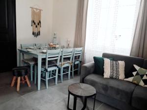 a living room with a table and a couch at Gite Aux Lauriers in Lacroix-sur-Meuse