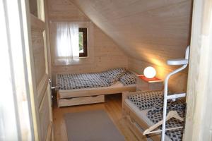 a small room with two beds and a window at Mountain chalet SmoLenisko domek w górach in Nowy Targ