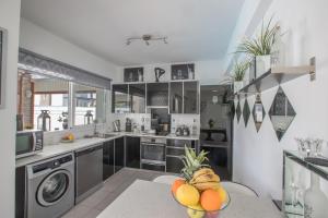 a kitchen with a bunch of fruit on a table at Villa Anemoni 8 in Protaras