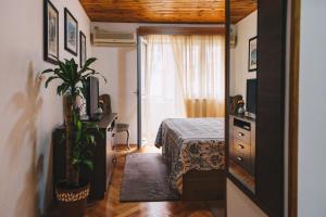 a bedroom with a bed and a dresser and a window at El Mar Apartments in Budva