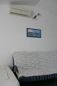 a room with a bed and a air conditioner on the wall at Apartmani Herceg in Karlobag