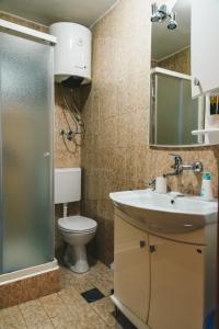 a bathroom with a toilet and a sink and a shower at El Mar Apartments in Budva +40 photos