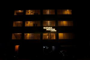 a building at night with a sign on it at Rathna Square in Pollāchi