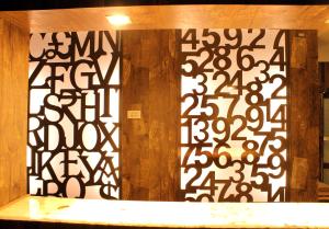 a room with a wall with black and white designs on it at Rathna Square in Pollāchi