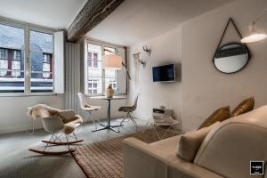 a living room with a couch and chairs and a table at Ma Poésie - Charme & emplacement idéal in Honfleur