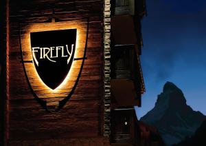 a sign on the side of a building at Firefly Luxury Suites in Zermatt