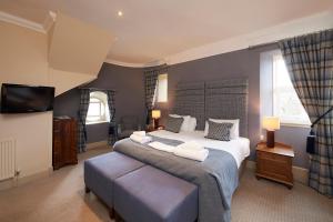 a hotel room with two beds and a television at Royal Golf Hotel in Dornoch