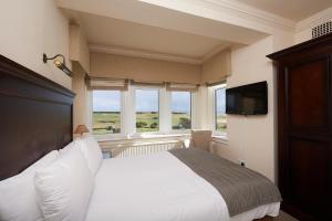 a bedroom with a television and a bed at Royal Golf Hotel in Dornoch