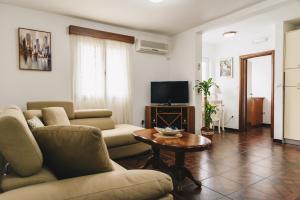 a living room with a couch and a table at El Mar Apartments in Budva