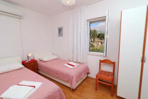 מיטה או מיטות בחדר ב-Guest House Franica & Pero Lobrovic