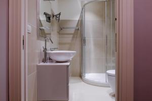 a bathroom with a sink and a shower and a toilet at San Pietro Rhome in Rome