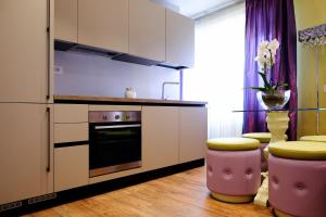 a kitchen with a refrigerator and two stools at San Pietro Rhome in Rome