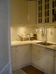 a kitchen with white cabinets and a sink at Casa Schlatter in Florence
