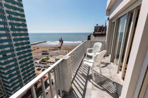 balcón con 2 sillas y vistas a la playa en Hotel Rivoli en Mar del Plata