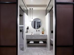 a bathroom with a sink and a mirror at InnAthens in Athens