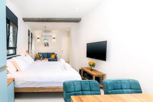a bedroom with a bed and a tv on a wall at Emanuel Boutique in Jerusalem