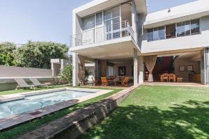 a house with a swimming pool in the yard at Houghton Place in Johannesburg