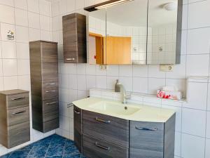 a bathroom with a sink and a mirror at Ferienwohnung Eichel in Rust