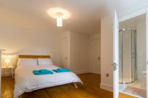 a bedroom with a bed and a glass shower at Host & Stay - Victoria Gardens in Ramsgate +9 photos