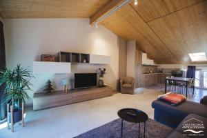 a living room with a couch and a tv at Antica Dogana in Pisogne