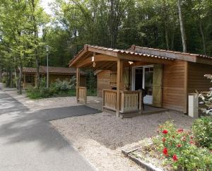 a small wooden cabin with a porch and a porch at Les Chalets Amneville in Amnéville