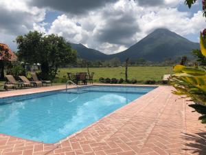 a swimming pool with a view of a mountain at Hotel Villas Vista Arenal in Fortuna