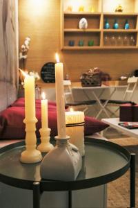a candle is lit on a table in a living room at Artistic Charming House in Caserta