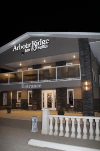 Arbour Ridge Inn & Suites في Kindersley: مبنى عليه لافته مكتوب عليها اجنحة جسر قاعه