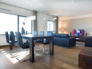 a living room with a dining room table and chairs at BizStay Harbour I Scheveningen Apartments in Scheveningen