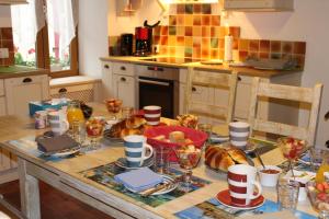 a kitchen with a table with croissants on it at Chambres d'hôtes de la Forge in Betz-le-Château